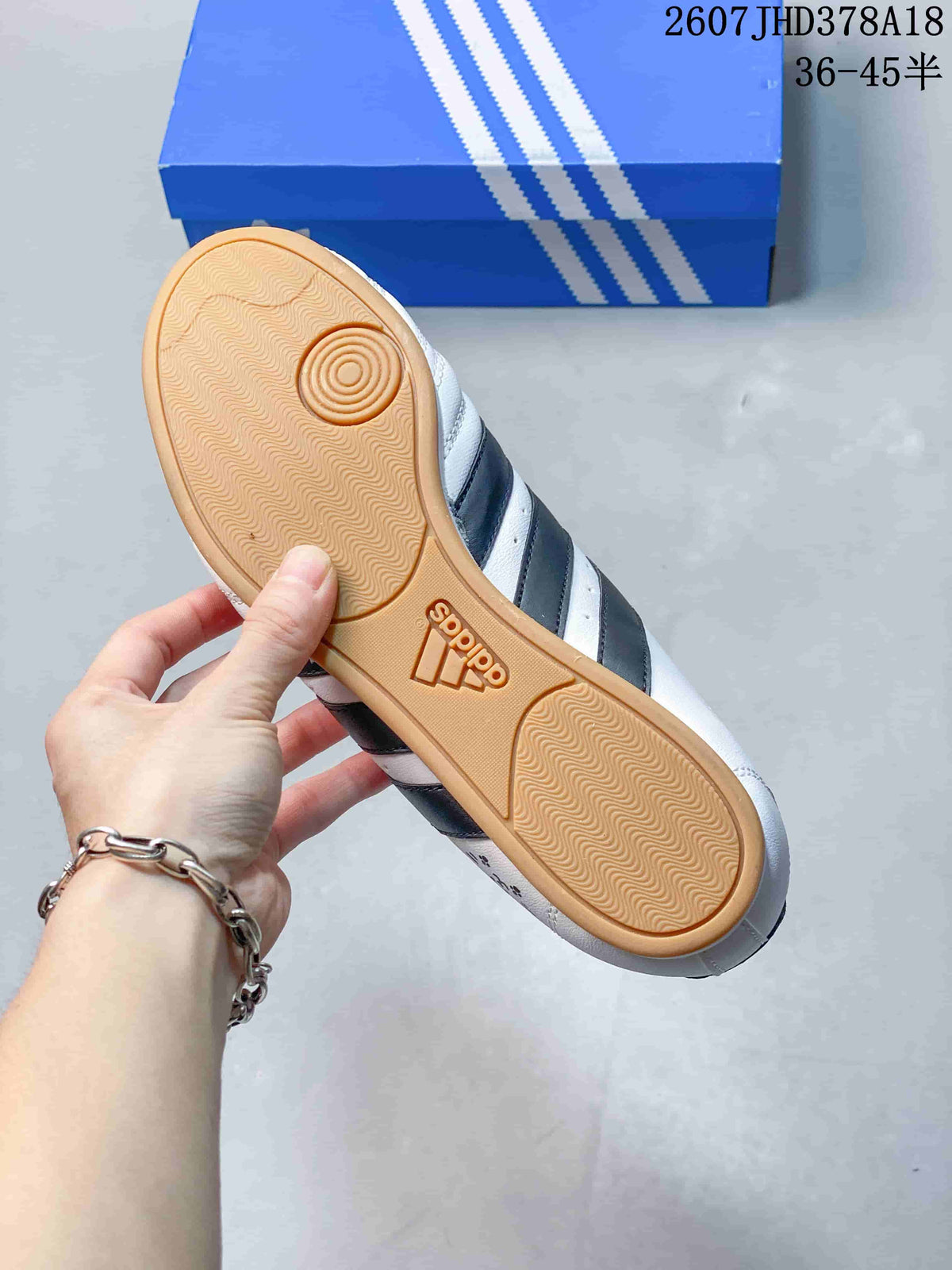 Close view of the gum-colored rubber outsole with textured tread and circular pivot detail.