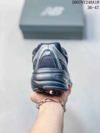 Rear view of a black and gray low-top sneaker highlighting the layered heel construction and outsole.