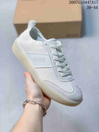 Angled side view showing the perforated white upper, tonal ECCO branding and translucent outsole.