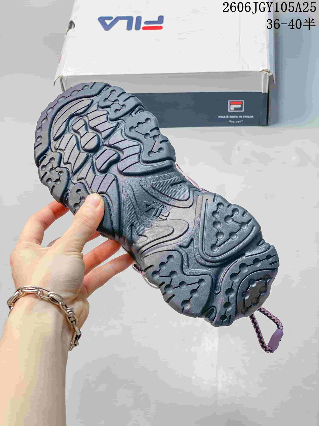 Close view of the dark sculpted outsole and tread on a FILA Fusion sneaker.