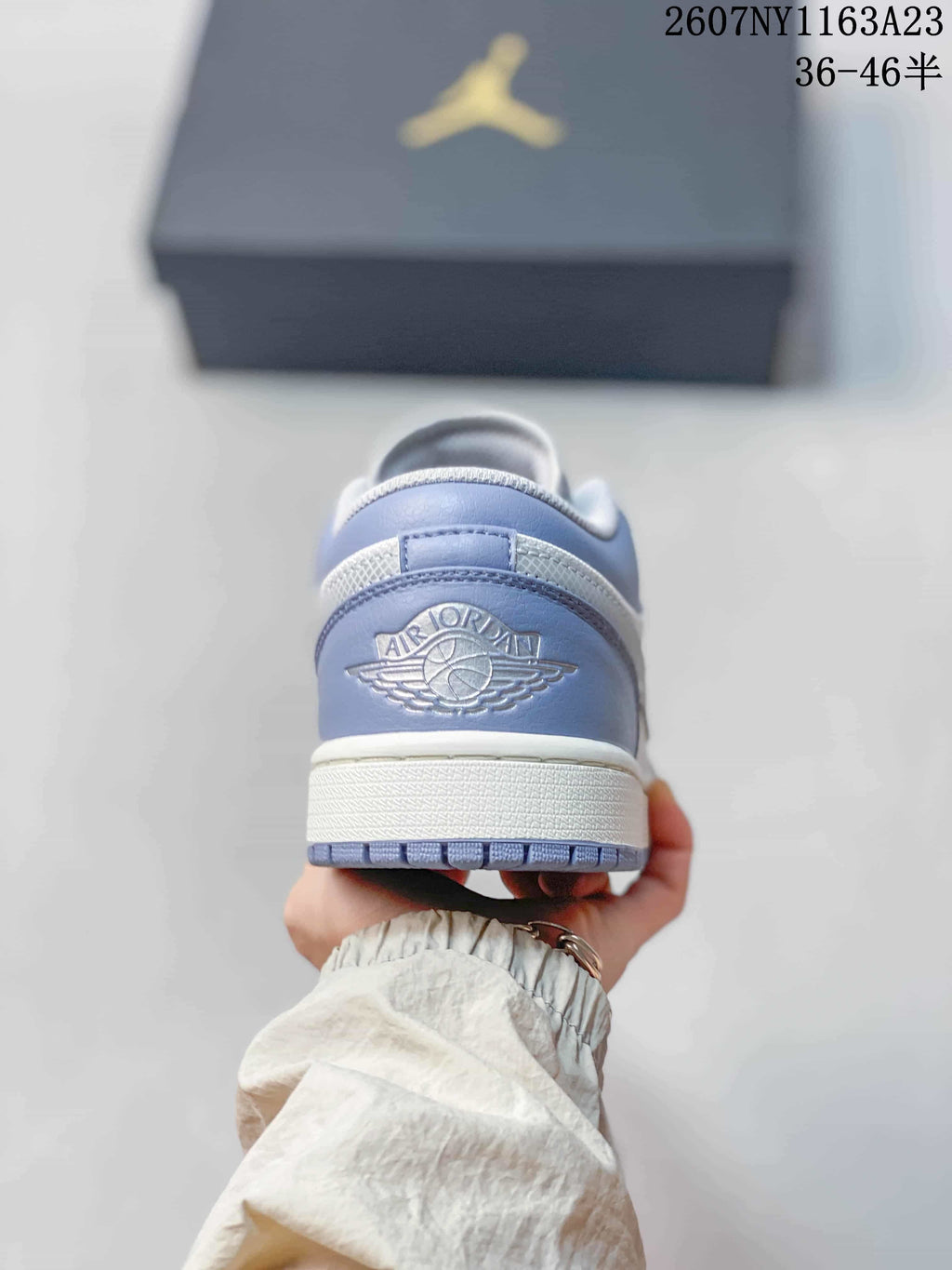 Rear view of the sneaker showing the Air Jordan winged logo on the light grey heel.