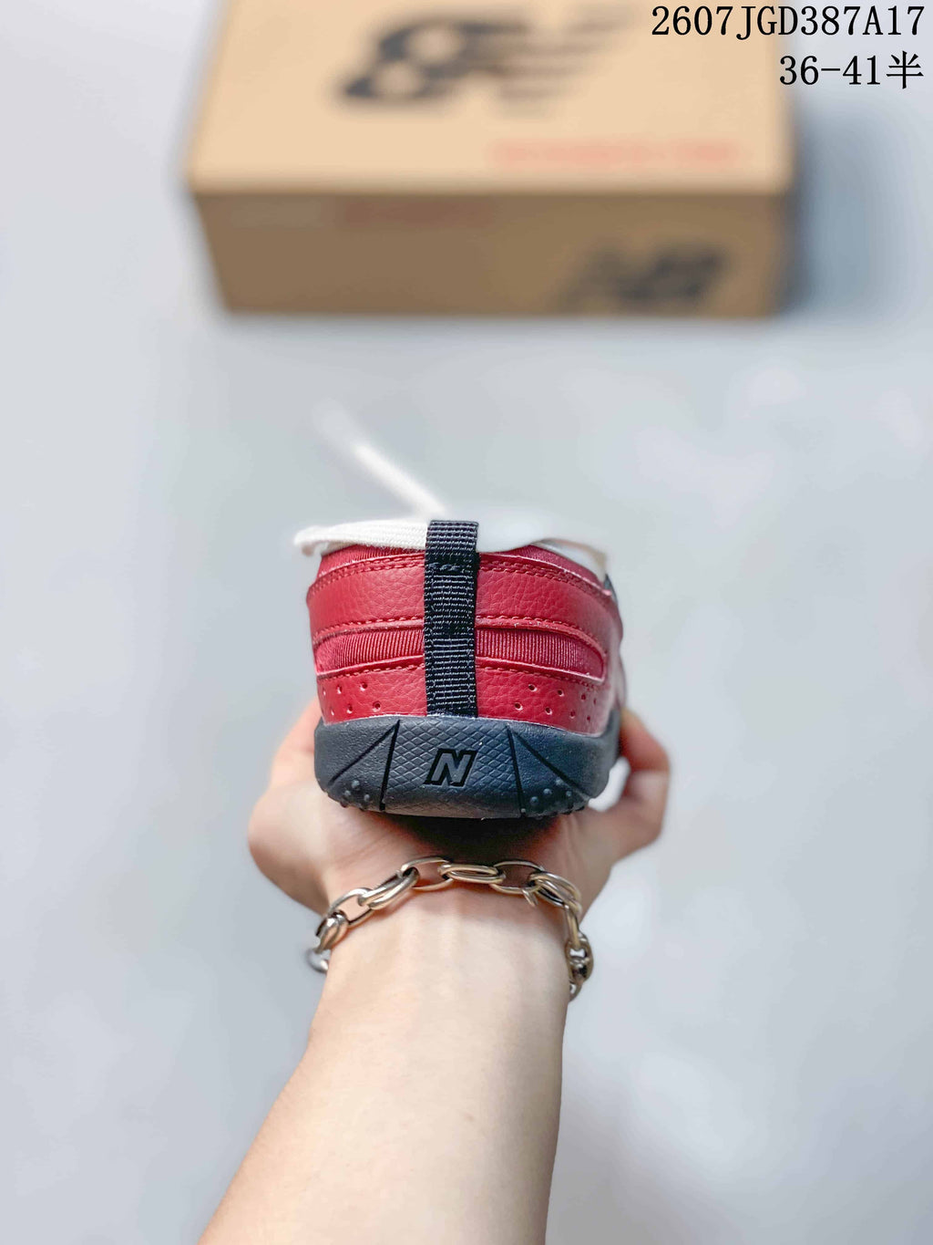 Rear view showing the red heel, white trim, black pull tab, and dark outsole.