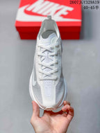 Top view of the white lace-up sneaker showing the perforated tongue area, layered upper, and rounded toe.