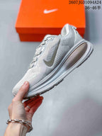 Side profile of the white and grey low-top sneaker showing the Nike side mark and sculpted sole.