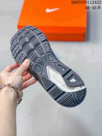 Close-up of the sneaker outsole showing a segmented black tread pattern with a contrasting central section.