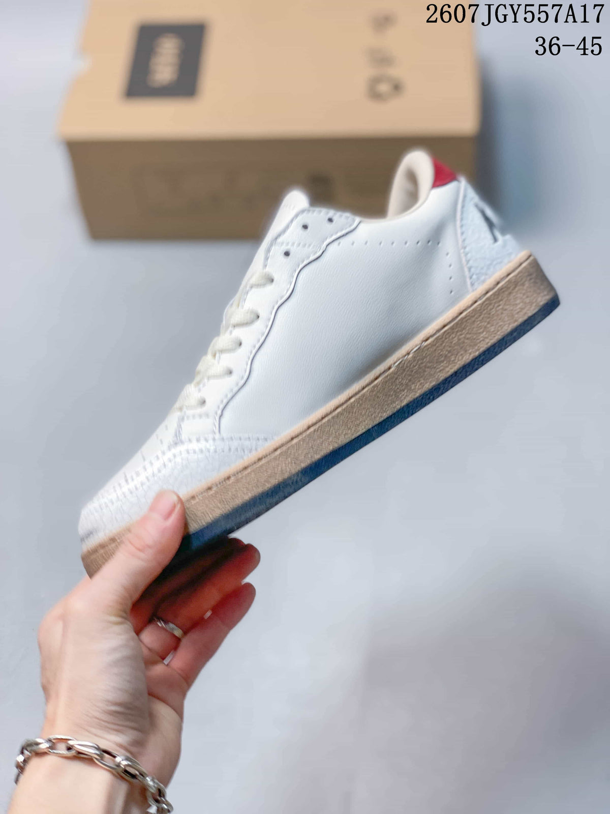 Side profile of the white low-top sneaker showing the lace area, smooth side panel, tan-colored sole edge, and dark outsole.