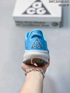Rear view of the blue sneaker showing the ACG heel logo, padded collar, and layered white midsole.