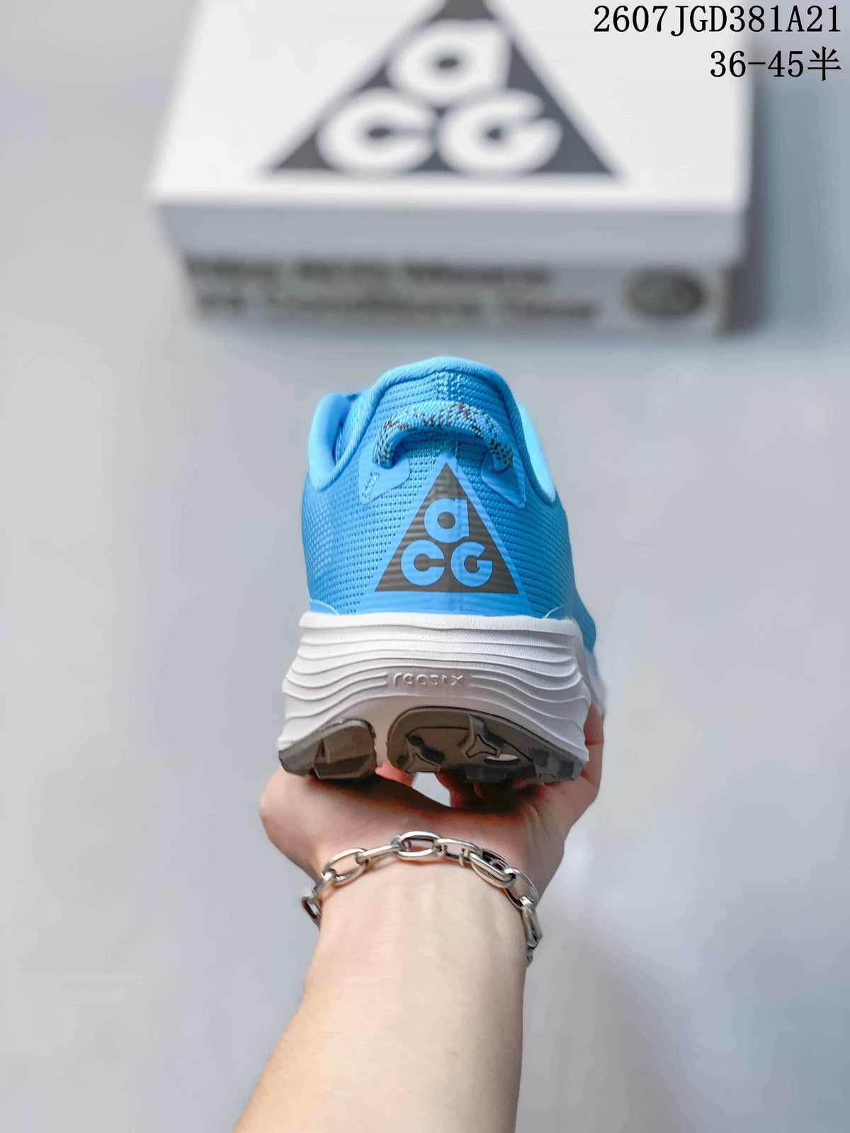 Rear view of the blue sneaker showing the ACG heel logo, padded collar, and layered white midsole.