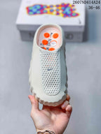 Top view of a white Nike Mind slip-on clog showing the perforated toe panel and small Swoosh detail.