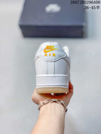 Rear view of the white low-top sneaker showing the Nike Air tongue branding and gum-colored outsole.