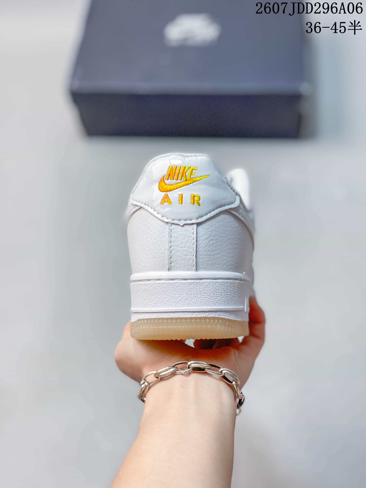 Rear view of the white low-top sneaker showing the Nike Air tongue branding and gum-colored outsole.