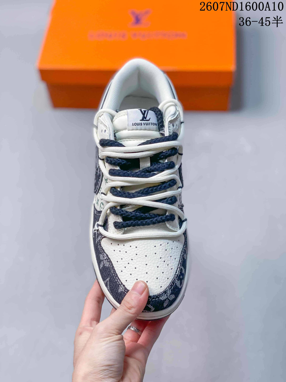 Top view showing the perforated white toe box, layered laces, tongue branding, and dark patterned overlays.