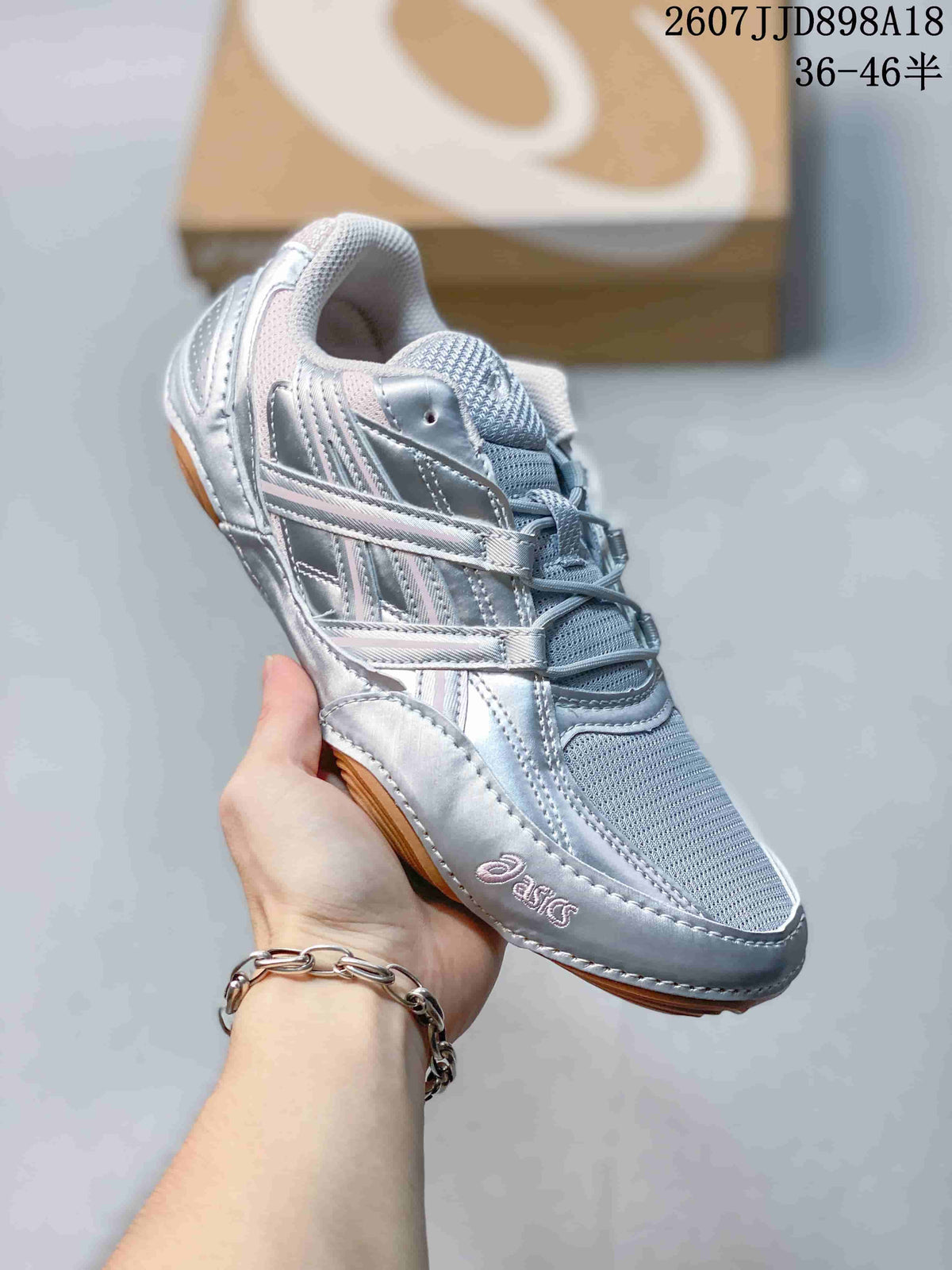 Angled side view highlighting the mesh toe area, silver overlays, ASICS branding, and gum-colored outsole.