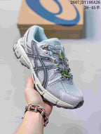 Angled side view of the ASICS Gel-Kahana 8 FL sneaker showing the layered upper, black side detailing, green lace hardware, and lugged outsole.
