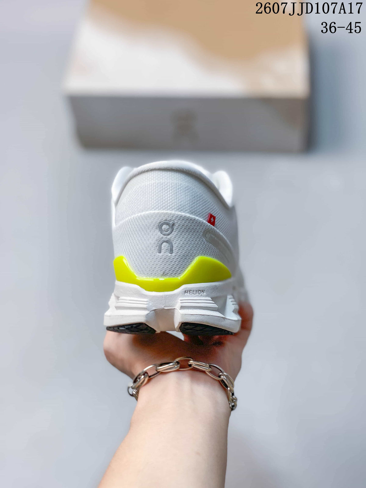 Rear view of the white sneaker showing lime heel accents, padded collar, and structured sole.