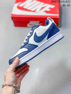 Side view of the blue and white mid-top sneaker showing the Swoosh, layered panels and white midsole.
