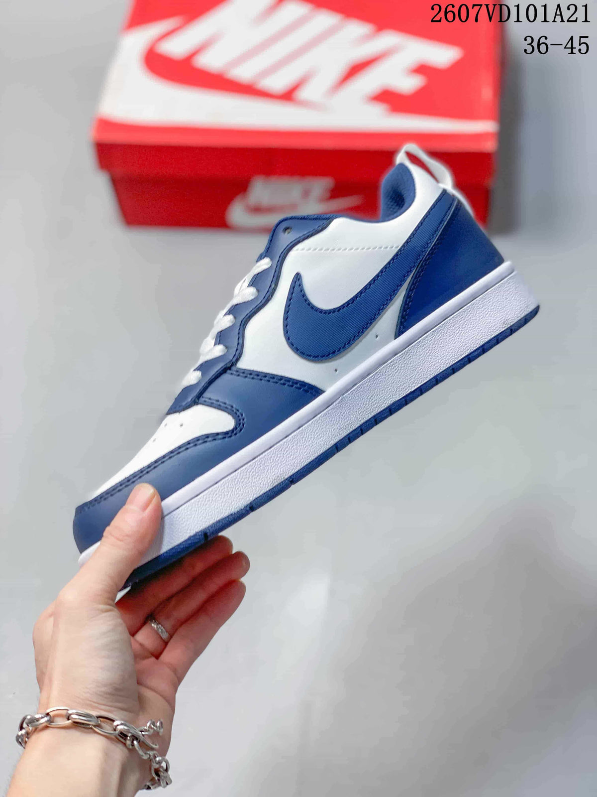 Side view of the blue and white mid-top sneaker showing the Swoosh, layered panels and white midsole.