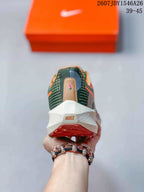Rear view of the Nike running shoe showing the heel branding, white midsole, and red-orange outsole section.