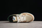 Top view showing the cream toe box, brown overlays, white laces, green collar, and tongue branding.