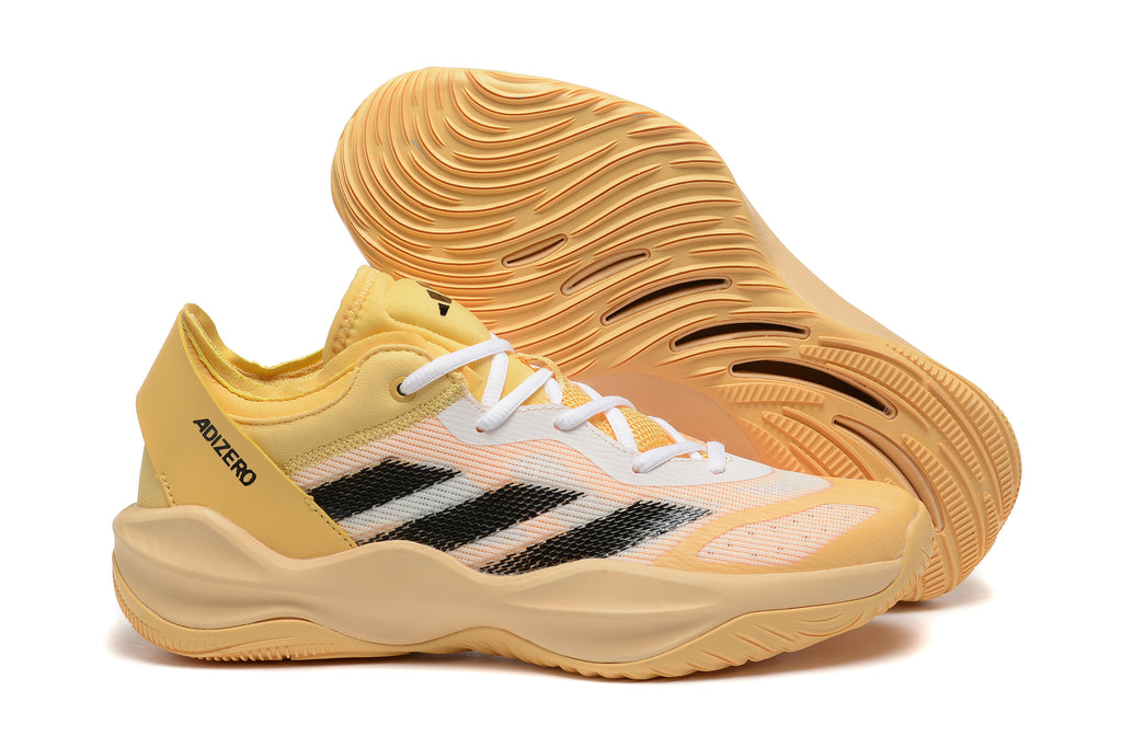 Adizero sneaker in pale yellow with black stripes and a warm yellow-orange sole