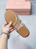 Close view of the textured gum-colored outsole with branded lettering and tread pattern.