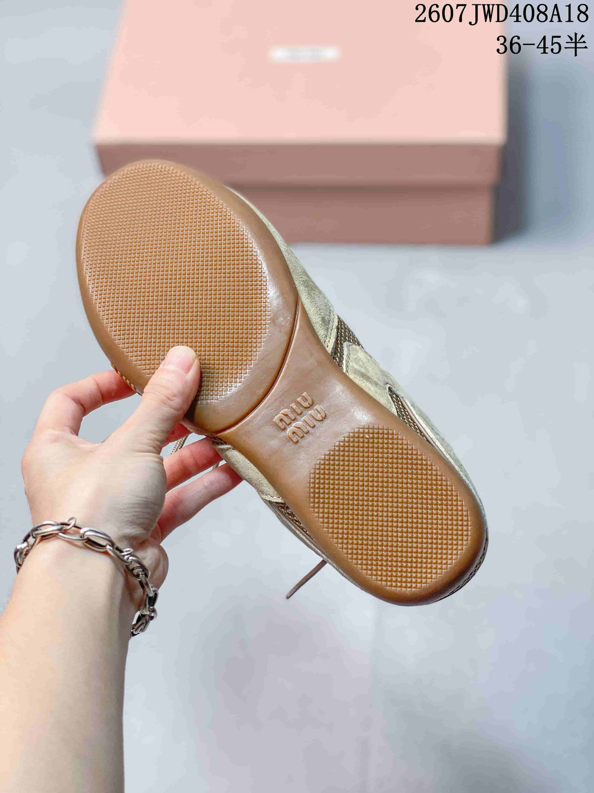Close view of the textured gum-colored outsole with branded lettering and tread pattern.