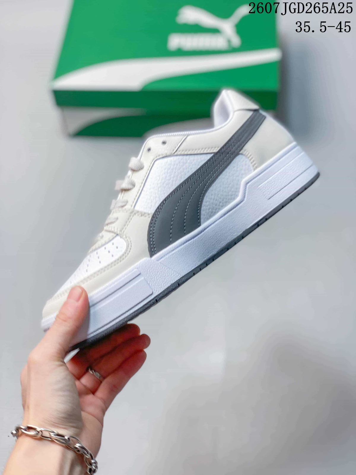 Side profile showing the gray side stripe, white upper, and raised sole.