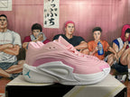 Side view of pink basketball shoe with white midsole and sculpted side panel