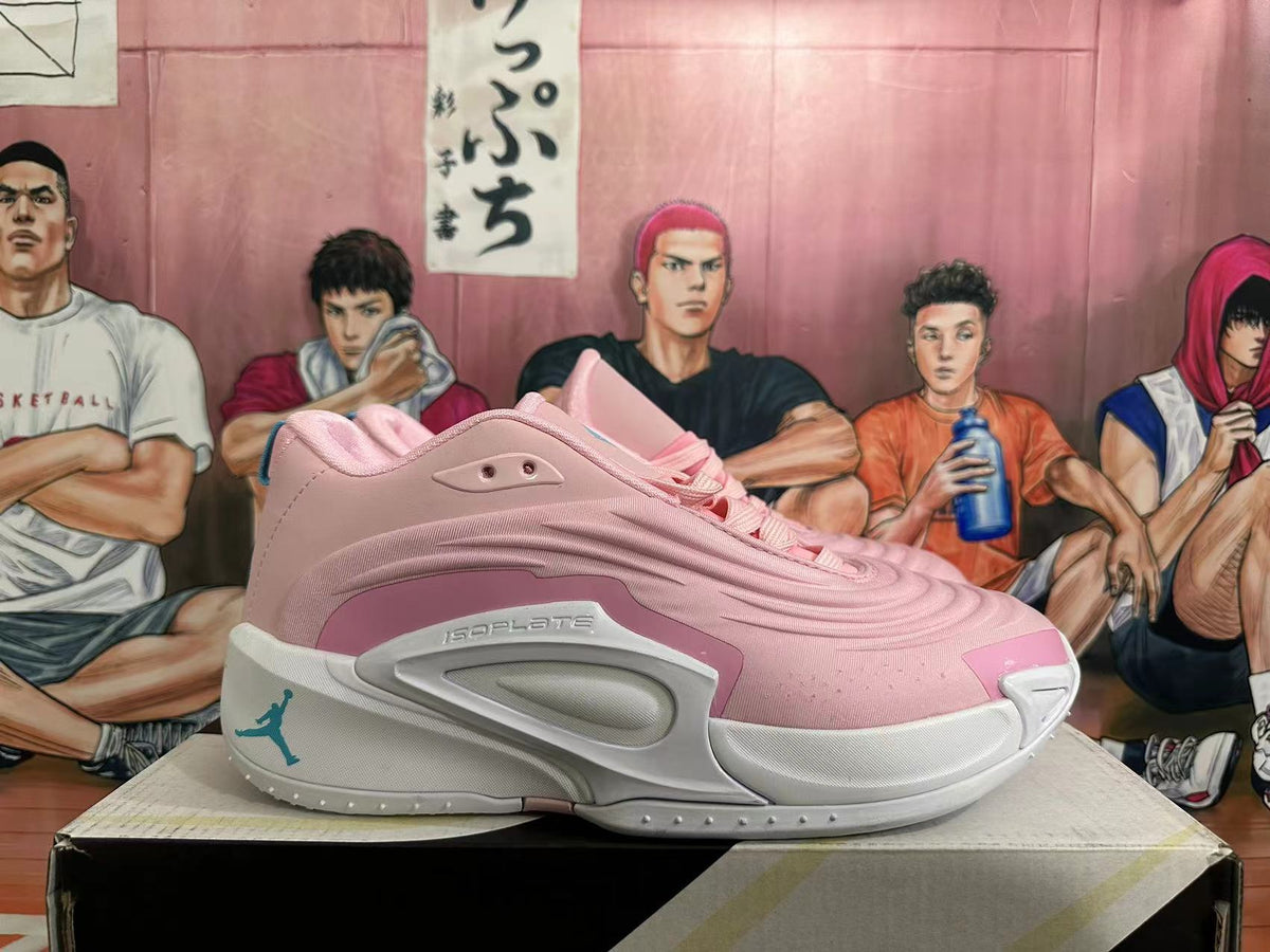 Side view of pink basketball shoe with white midsole and sculpted side panel