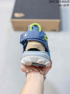 Rear view of the blue sandal showing the padded heel area, pull loop and textured outsole.