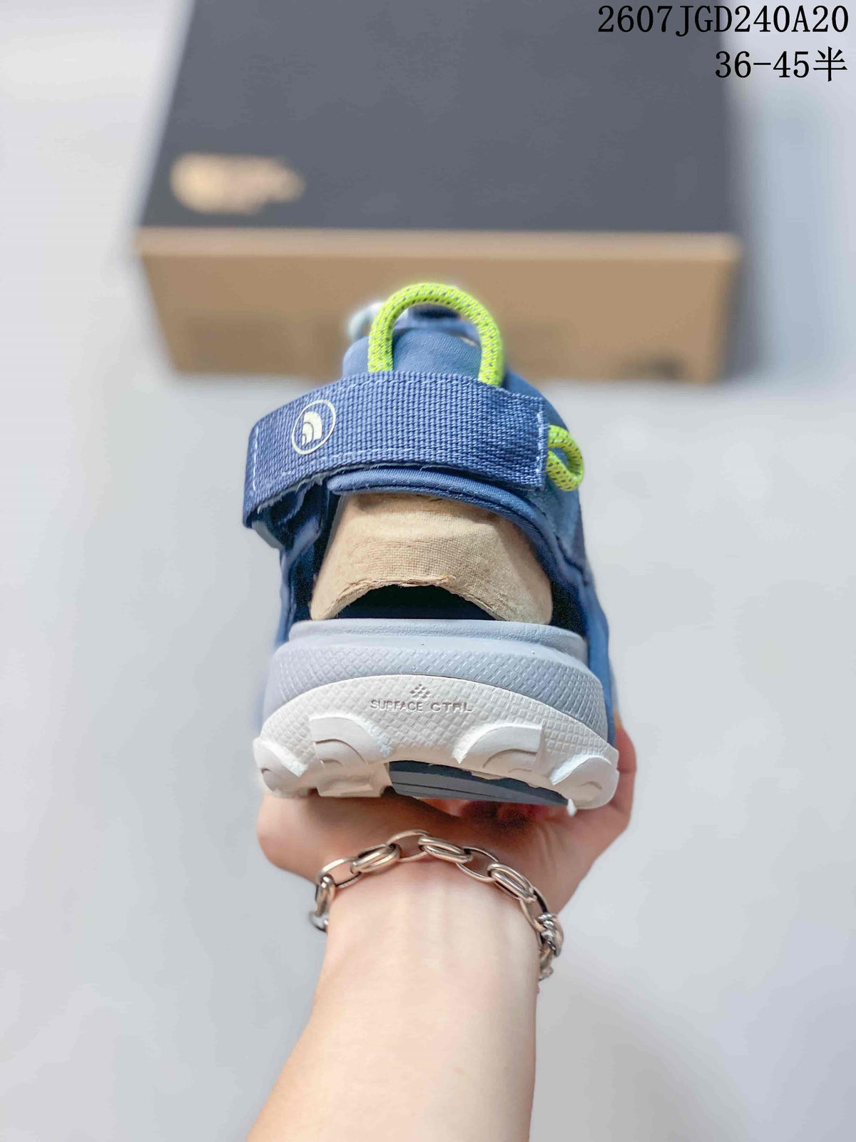 Rear view of the blue sandal showing the padded heel area, pull loop and textured outsole.