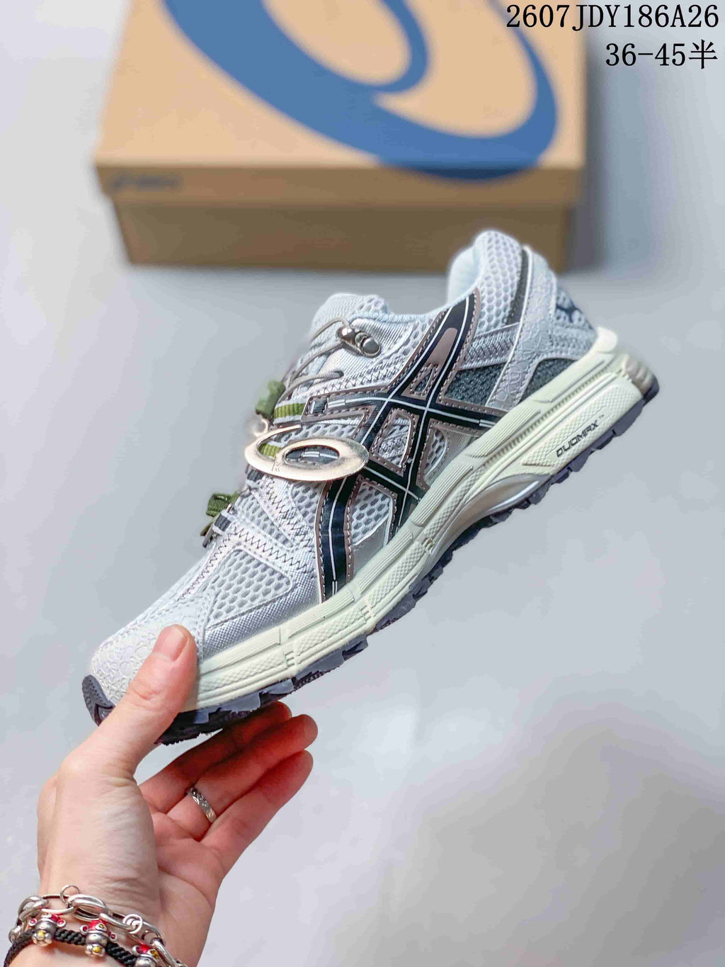 Side view of the light gray ASICS Gel-Kahana 8 FL sneaker showing the black ASICS side logo, overlays, and outsole tread.