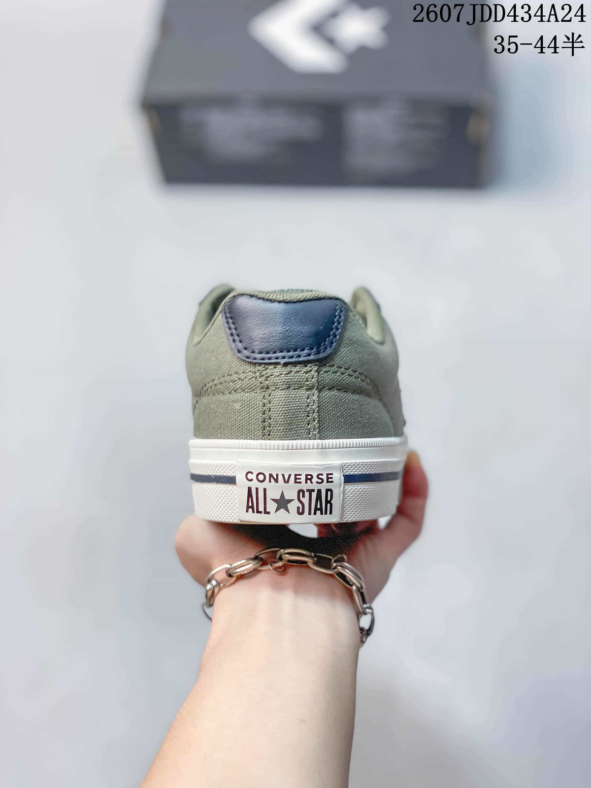 Rear view of the green sneaker showing the heel patch, white midsole, and visible Converse All Star branding.