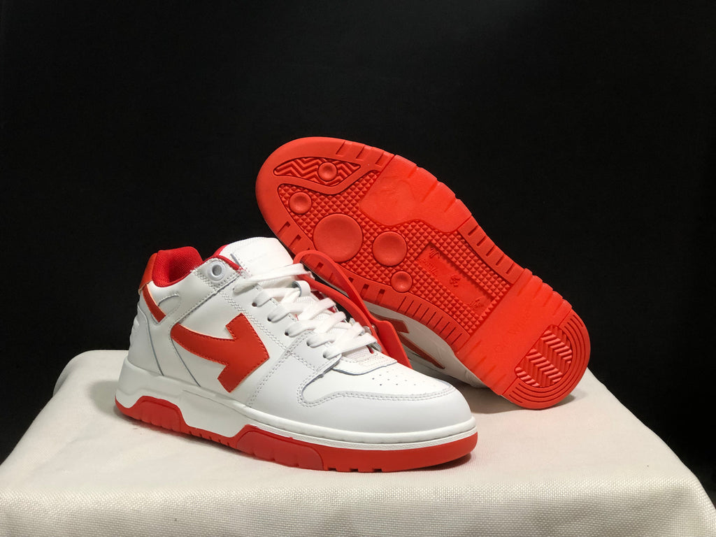Angled view of one sneaker beside an upturned shoe showing the patterned red outsole.