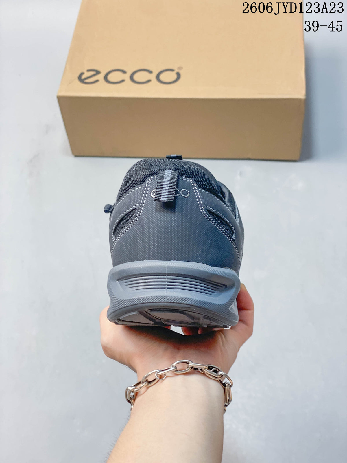 Rear view showing the heel and outsole of the gray sneaker.