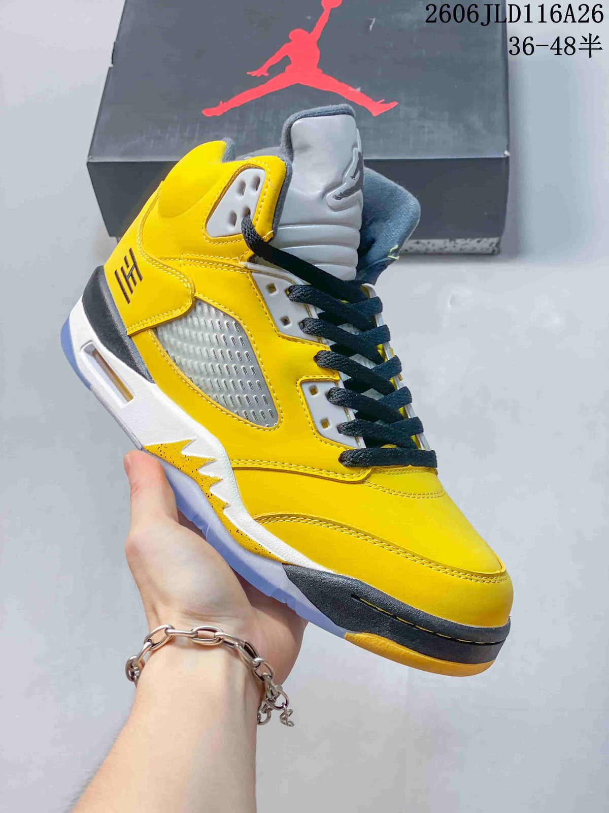 Side view of a yellow Air Jordan 5 high-top sneaker with dark laces
