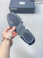 Close view of the shoe outsole showing textured grip panels and an Onitsuka Tiger logo detail.