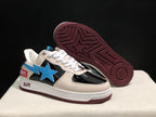 Angled outsole view showing the burgundy geometric tread pattern beneath the cream and black low-top sneakers.