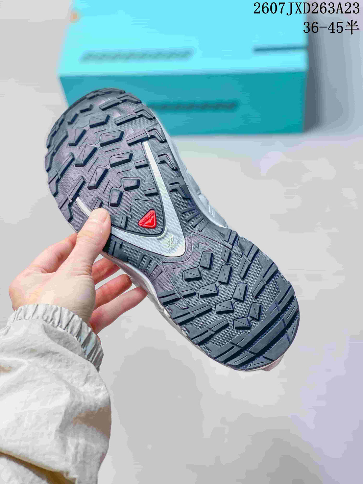 Close view of the Salomon XA Pro 3D outsole showing a dark, deeply lugged tread pattern with a red Salomon detail.