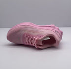 Top and outsole-side view of a pink Alo sneaker showing the lace area, tongue branding, and upper texture.