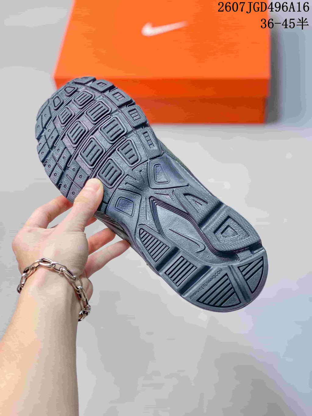 Close view of the sneaker outsole showing its molded geometric tread pattern.
