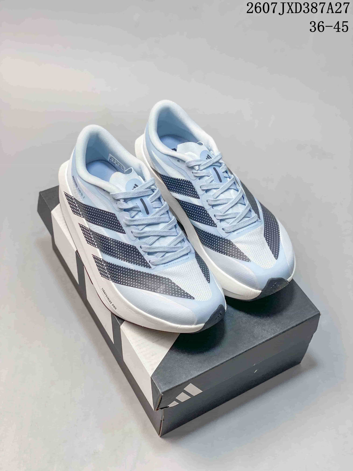Pair of light blue adidas running shoes displayed on a shoebox, showing the dotted side stripes and white midsoles.