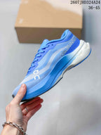 Side view of the blue On running shoe showing layered upper panels, side branding, and the sculpted white-and-blue midsole; image text shows style code 2607JHD324A24 and size range 36–45.