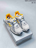 Pair of grey and yellow New Balance NB204 sneakers displayed on a shoe box.