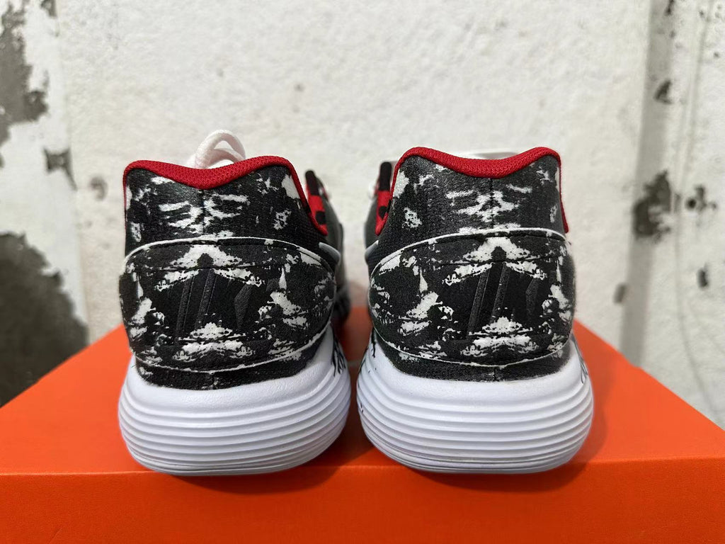 Rear view of black-and-white patterned Nike shoes with red trim and white soles