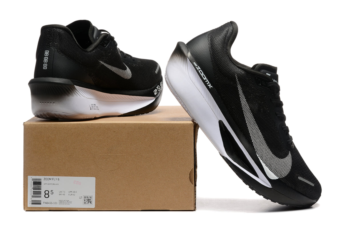 Black Nike Zoom Fly 6 shoes with white details beside a box showing a sample size label