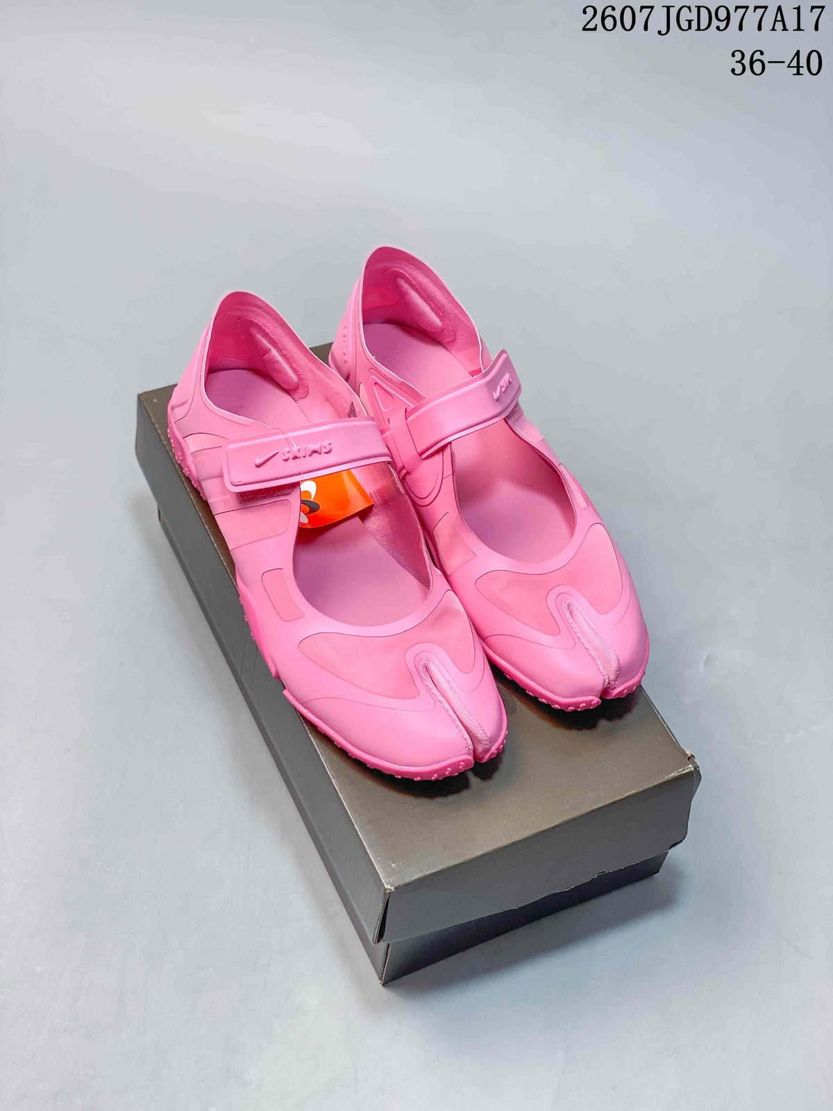Pair of pink Nike x SKIMS split-toe sneakers displayed on a shoebox, with style code 2607TGD977A17 and size range 36–40 visible above.