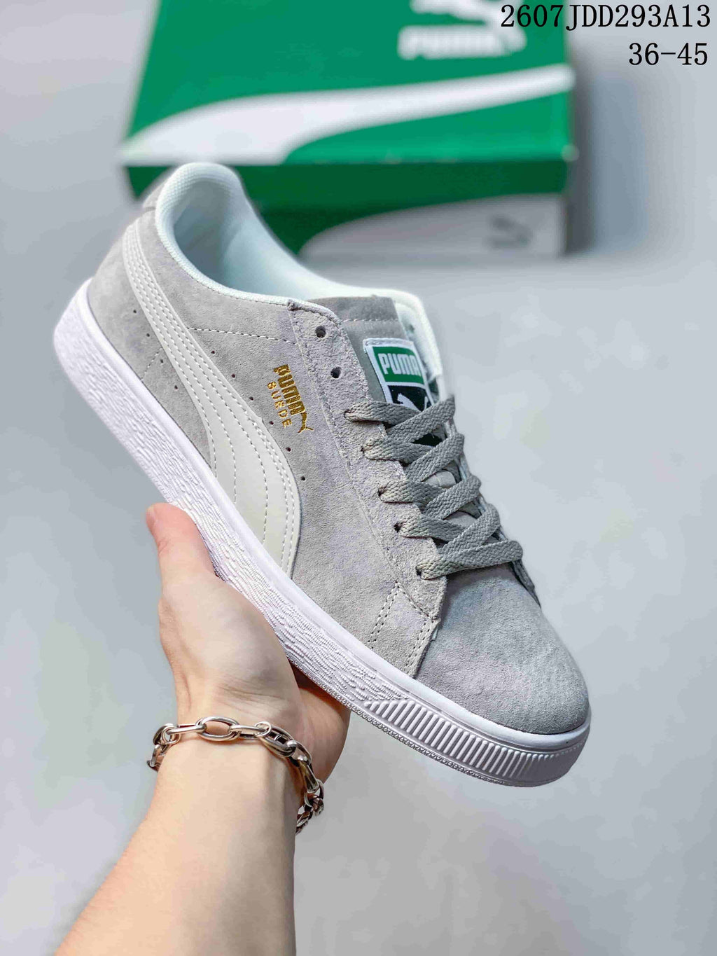 Light gray PUMA Suede XL sneaker with white side stripes, gray laces and a white outsole.