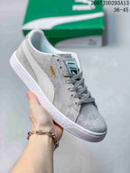 Light gray PUMA Suede XL sneaker with white side stripes, gray laces and a white outsole.