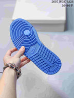 Close view of the bright blue rubber outsole with circular traction and molded tread patterns.